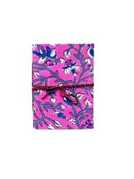 A6 sized notebook with a vibrant, colorful floral pattern in shades of pink, purple, and blue. The notebook has a soft, textured cover and blank pages inside.