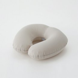 Beige neck pillow, soft and comfortable for travel or relaxation.
