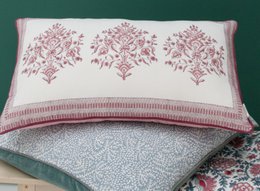 A decorative throw pillow with a floral damask pattern in shades of pink and white. The pillow has a rectangular shape and a textured surface.