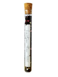  A tube of heart-shaped tea, perfect for a thoughtful gift or personal enjoyment. The tea is packaged in a clear tube with a cork stopper, showcasing the unique heart-shaped tea leaves inside.
