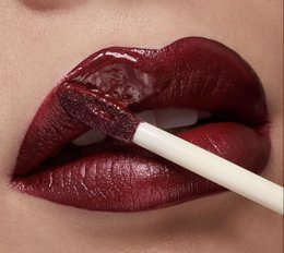 Brownie-colored lip gloss with a shiny, glossy finish. Provides a natural, hydrating tint for the lips.