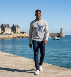 Grey crew neck sweater with intarsia starfish design. Made of soft, comfortable material. Available in sizes Small, Medium, and Large.