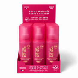 Bright pink body and hair mist spray bottle, fragrant cosmetic product for body care.