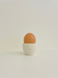 Handcrafted egg cup made of jesmonite in various pastel colors including white, beige, pink, blue, green, and gray. Designed with a simple, minimalist style.