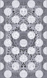 A monochrome rug with a repeating pattern of circular shapes in varying shades of gray and white. The rug has a modern, geometric design that would complement a variety of interior styles.