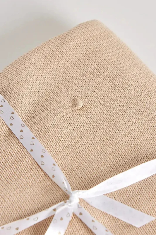 Coperta in maglia di cotone per bambini con pompon