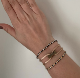  Satin cord bracelets in brown, beige, and green colors. The bracelets feature a simple, minimalist design with metal accents.