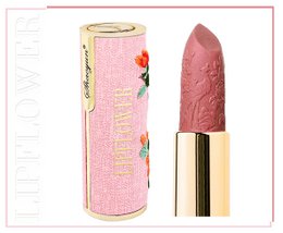 A pink lipstick with a floral pattern on the packaging. The lipstick appears to be a creamy, pink shade.
