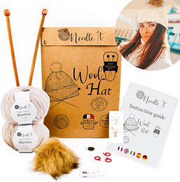 Ecru wool hat knitting kit with needles, yarn, and instructions for making a warm, cozy hat for children and adults.