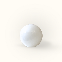 Selenite sphere, a decorative bowl available in 3 cm and 10 cm sizes, made of a translucent white mineral with a smooth, rounded shape.