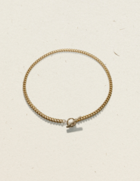 Gold-toned charm bracelet with a clasp closure and a delicate, intricately woven chain design.