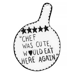 White ceramic cutting board with text "Chef was cute, would eat here again" and star design.