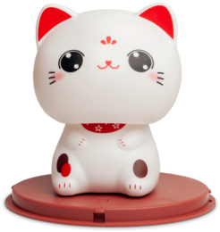 A white ceramic figurine of a lucky cat with large eyes, red ears, and a red collar. The cat is sitting on a red platform.