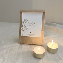 White bath bombs with floral design and "With Love" text on packaging.