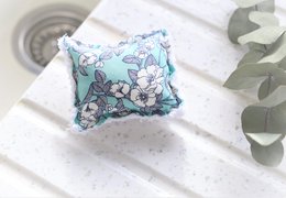 Reusable kitchen sponge with floral and animal patterns in various colors.