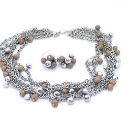  A multi-strand necklace with interlocking silver and black chain links, creating a bold and stylish accessory.