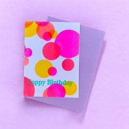 "Happy Birthday greeting card with colorful circles, pink yellow red design, festive celebration card"
