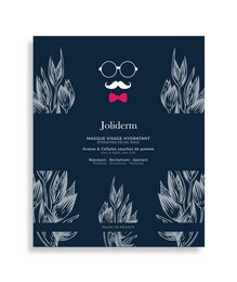 A navy blue face mask with a mustache and bow tie graphic, designed for men's skincare. The mask is described as moisturizing and contains ingredients like aloe vera and vitamin E.
