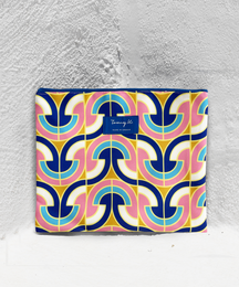 "Colorful, retro-inspired clutch with a bold, geometric pattern in shades of blue, pink, and orange."