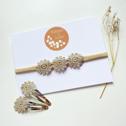 Gold flower headband with daisy accents, perfect for newborn girls.