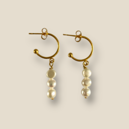 Gold-toned earrings with dangling pearl beads.