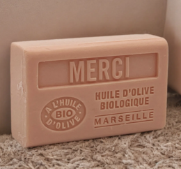 Organic olive oil soap bar from Marseille, France. Rectangular shape with "MERCI" text embossed on the surface.