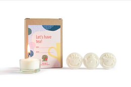 White round tealight candles in a box with the text "Let's have tea!" on the packaging.