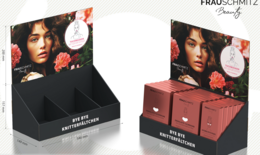 Counter display with 100 cloth face masks in various colors and styles. Includes a variety of floral and feminine designs.