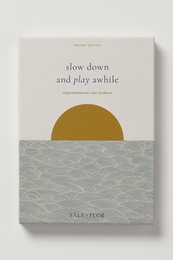 A children's book with a simple, minimalist cover design featuring a sun and waves, titled "Slow down and play awhile".