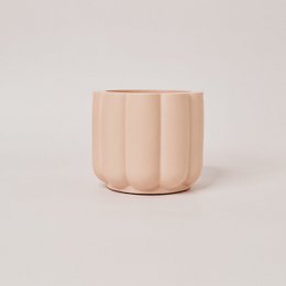 Tall, round, scented candle in white, yellow, and salmon colors.