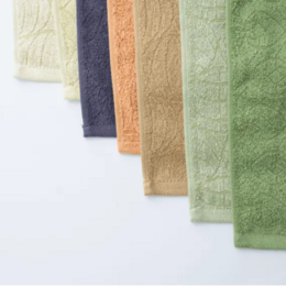 Green handkerchief-style pocket towel made from natural dyed cabbage material.