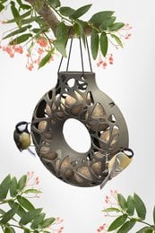 Recycled plastic bird feeder with a unique circular design featuring cutouts in the shape of birds. Made from 100% recycled materials, this feeder is durable and environmentally friendly. Suitable for attracting a variety of wild birds to your garden or outdoor space.