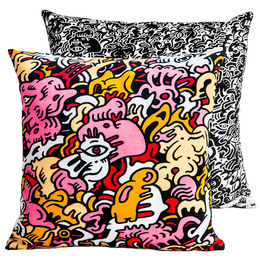 Velvet cushion with a vibrant, abstract pattern in shades of pink, yellow, and black. The pattern features whimsical, cartoon-like shapes and designs, creating a bold and eye-catching look.