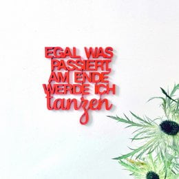 A red embroidered patch with the text "EGAL WAS PASSIERT, AM ENDE WERDE ICH TANZEN" (German for "No matter what happens, I'll end up dancing").