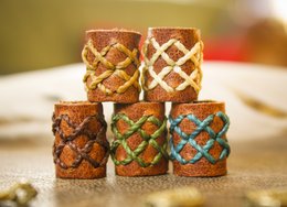 Leather dreadlock beads with double stitched rows or beard beads in various colors and sizes, including beige, dark brown, white, green, and blue, with diameters ranging from 6mm to 18mm.