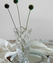 "Clear crystal glass vase, textured surface, tall cylindrical shape, modern decorative floral arrangement"