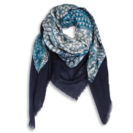 Rectangular scarf with a patterned design featuring shades of blue, gray, and black. The scarf has a soft, textured appearance and appears to be made of a lightweight, woven material.
