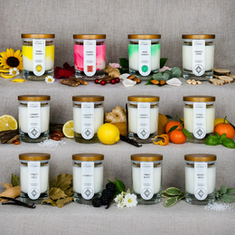 "Set of 12 soy wax scented candles, cylindrical glass jars with gold lids, various colors including yellow, pink, green, white"