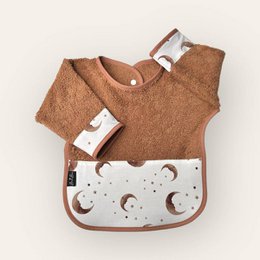 A brown terry cloth bib with a moon and star pattern. The bib has a snap closure and is designed to be worn by a baby or toddler.