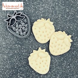 White, heart-shaped strawberry-shaped baking decorations.
