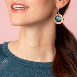 Petrol blue drop earrings with a round, sunburst-style design featuring a turquoise-colored center.