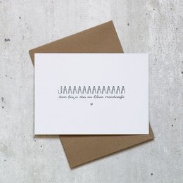 A simple, minimalist greeting card with the text "JAAAAAAAAAAAAA" printed on a white card with a brown envelope.
