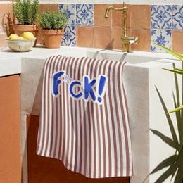 Striped kitchen towel with bold blue "F*ck!" text, taupe and white vertical stripes, humorous design.