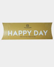 Gondola box Happy Day - 20 grams of green tea with yellow and red accents, packaged in a gold-colored box with the text "Happy Day" printed on it.
