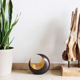 A round, bronze/golden tealight holder with a crescent moon shape cutout, measuring 14.5cm in diameter. Suitable for use with tealight candles.