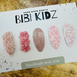Set of 13 non-slip hair clips for kids, featuring various shapes and patterns in pink and white colors.