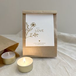 White bath bombs with floral design and "With Love" text on packaging.