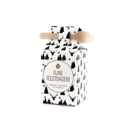 Herb butter in a festive holiday-themed box with a pine tree and snowflake pattern. The product is a spice mix for cooking and seasoning.