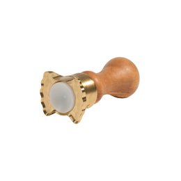 Butterfly-shaped brass ravioli-cutting mold for making homemade pasta. Features a wooden handle and a decorative brass cutting edge in the shape of a butterfly.