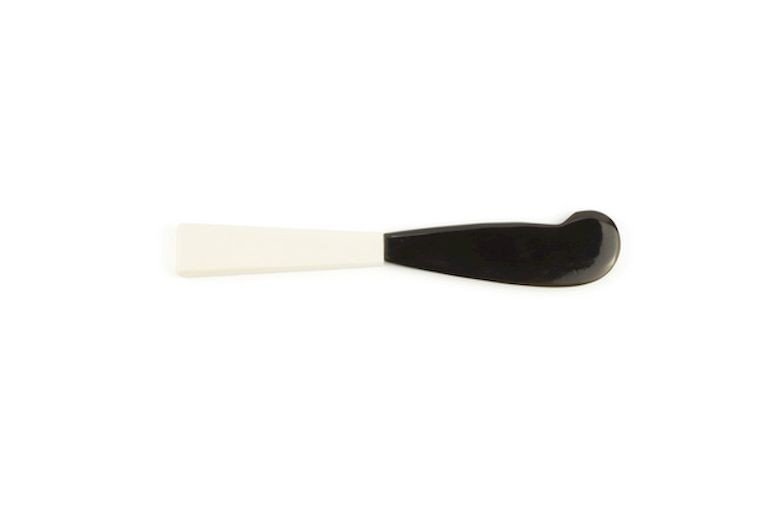 Butter knife with bone handle and black horn blade